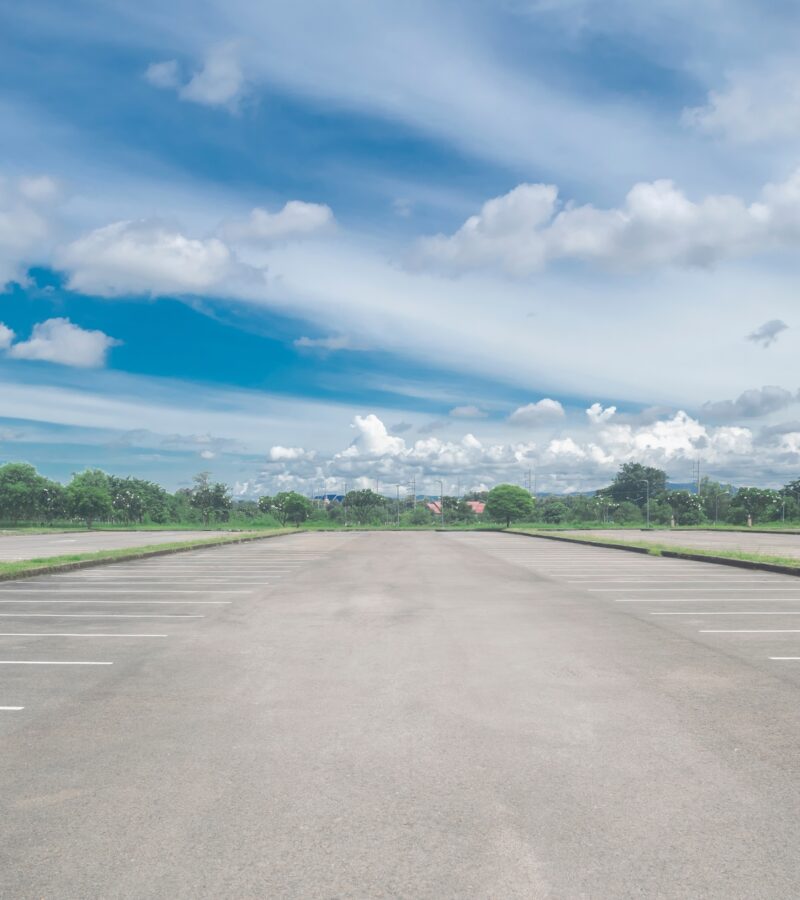 Wide,Empty,Asphalt,Parking,Lot,Background.,With,Many,Cars,Parked